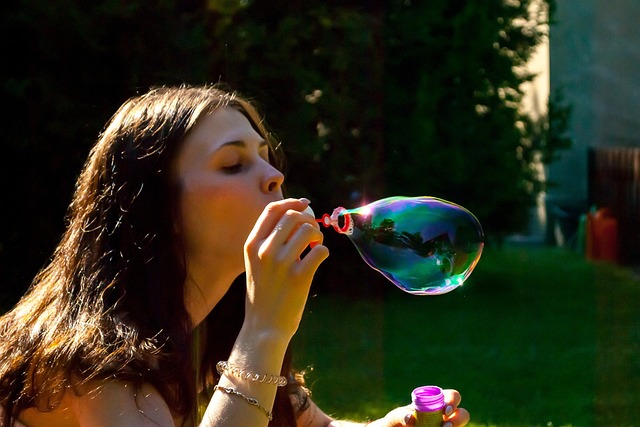 alt= "woman making a bubble representing the importance of letting go"